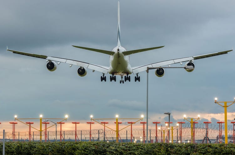 Plane landing on the airport at the sunset time