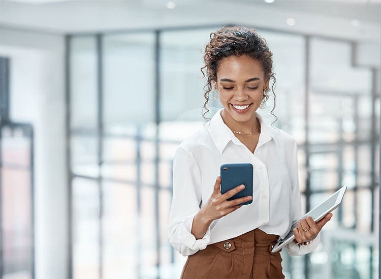 An attractive young businesswoman sending a text while working in her office